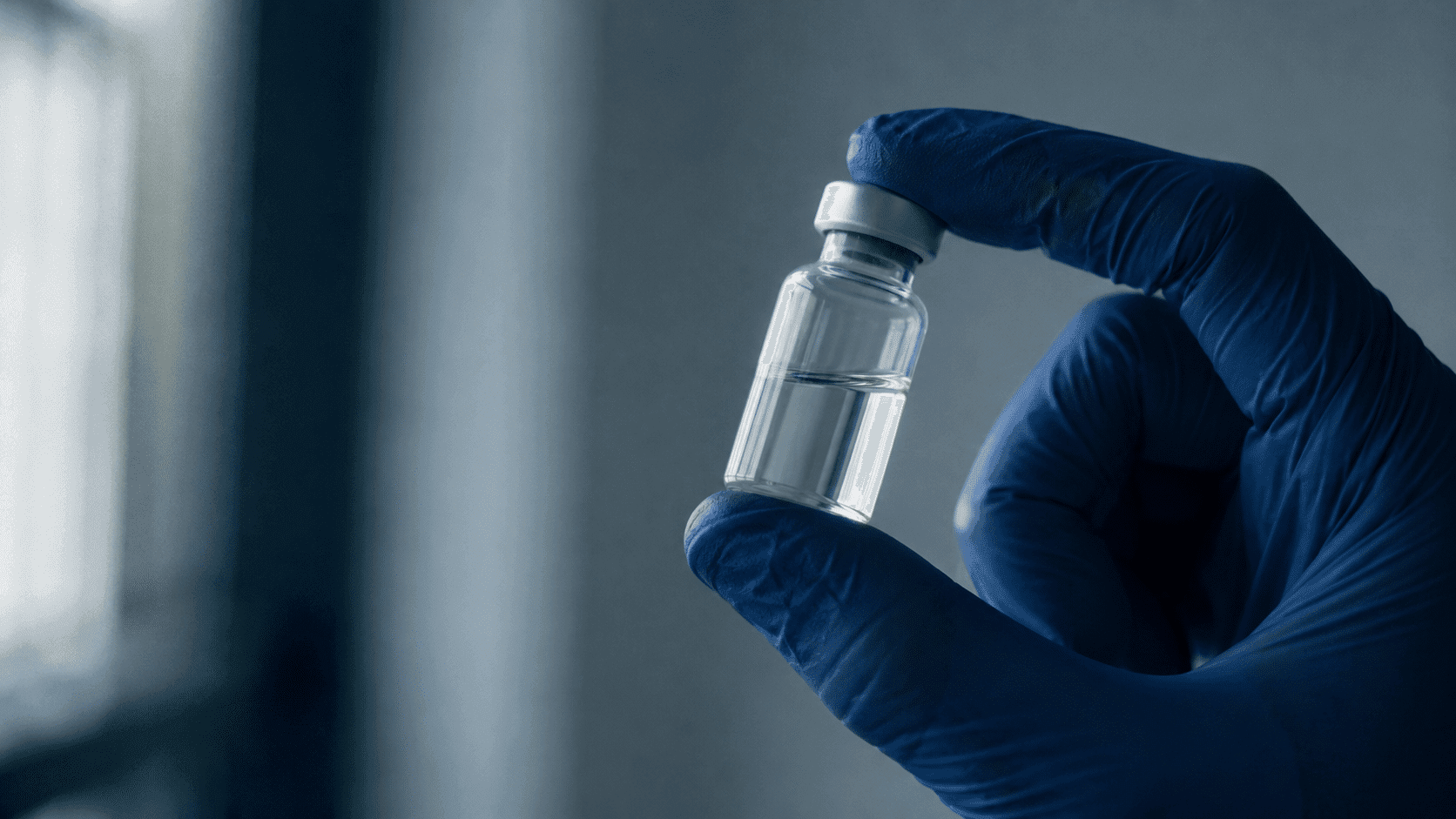 Researcher holding a small vial of BPc-157